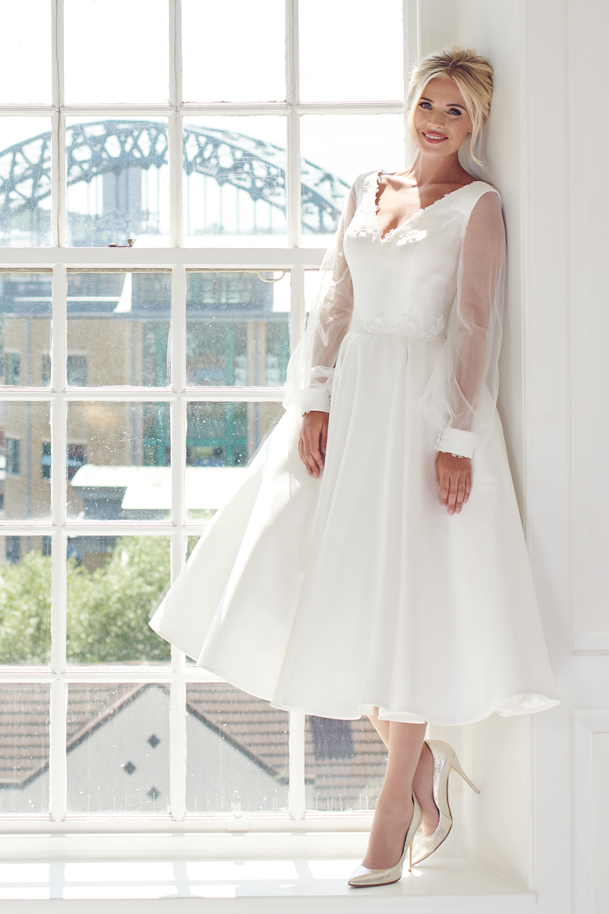 Cream brocade off the shoulder bardot neckline short tea length wedding dress with pockets. rear view