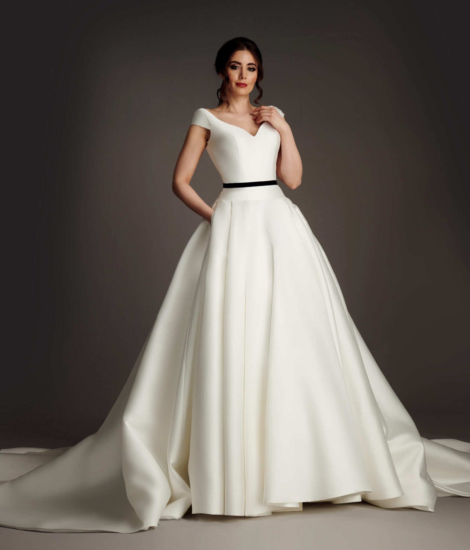Sophisticated and elegant mikado ballgown with draped sleeve and diamante beading