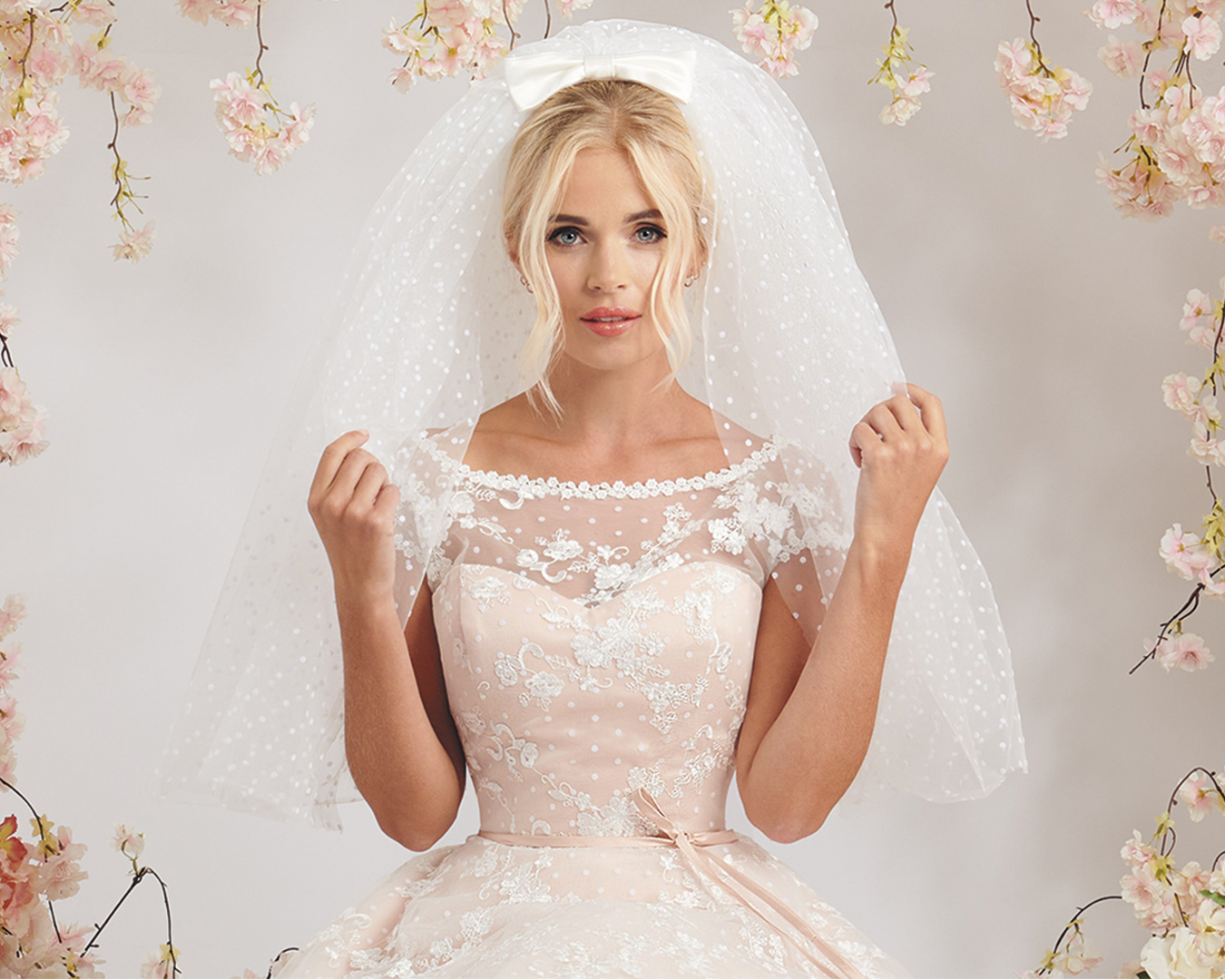 Aria — Blush Pink Polka Dot Lace Wedding Dress with Illusion Neckline | House of Mooshki Aria wedding dress bodice detail with ivory lace on blush spotted tulle and satin waist bow.