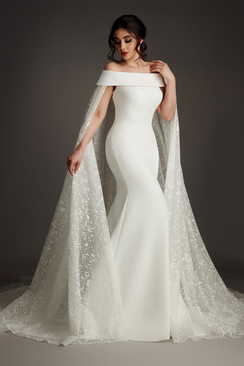 Athena satin fishtail wedding dress with folded portrait collar and sheer lace sleeves. (86 characters)