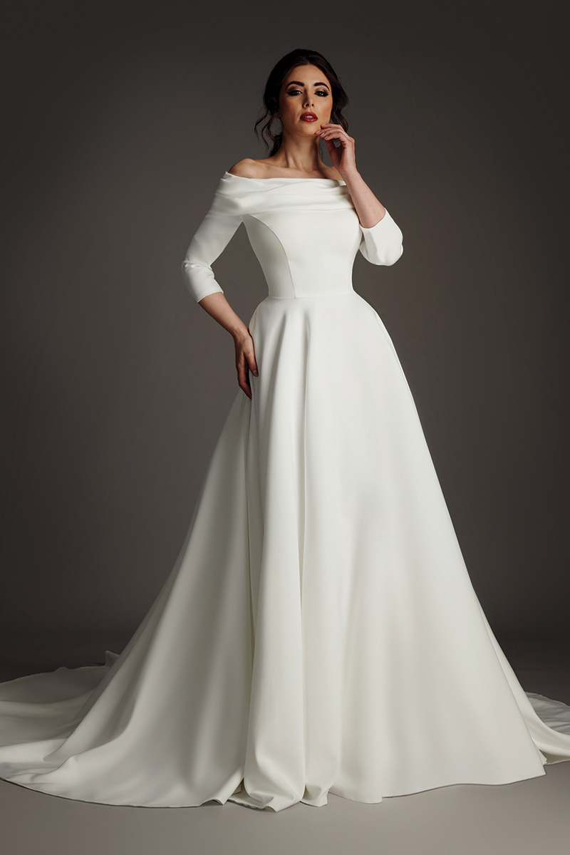 Louisa crepe wedding dress with deep V neckline, flared cape sleeves and fishtail train.