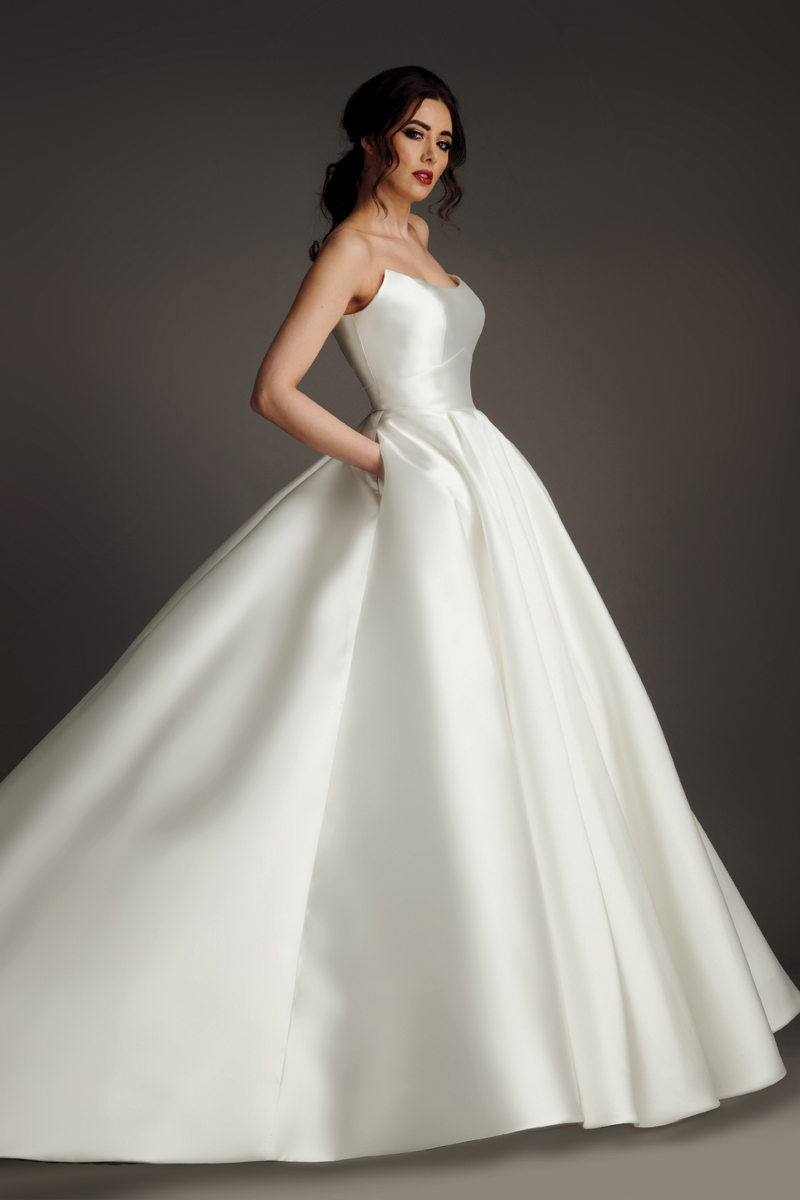 Geneva strapless satin ballgown wedding dress with open back, box pleats and cathedral train.