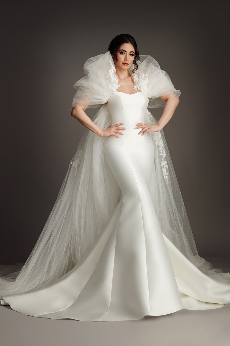 Athena satin fishtail wedding dress with folded portrait collar and sheer lace sleeves. (86 characters)