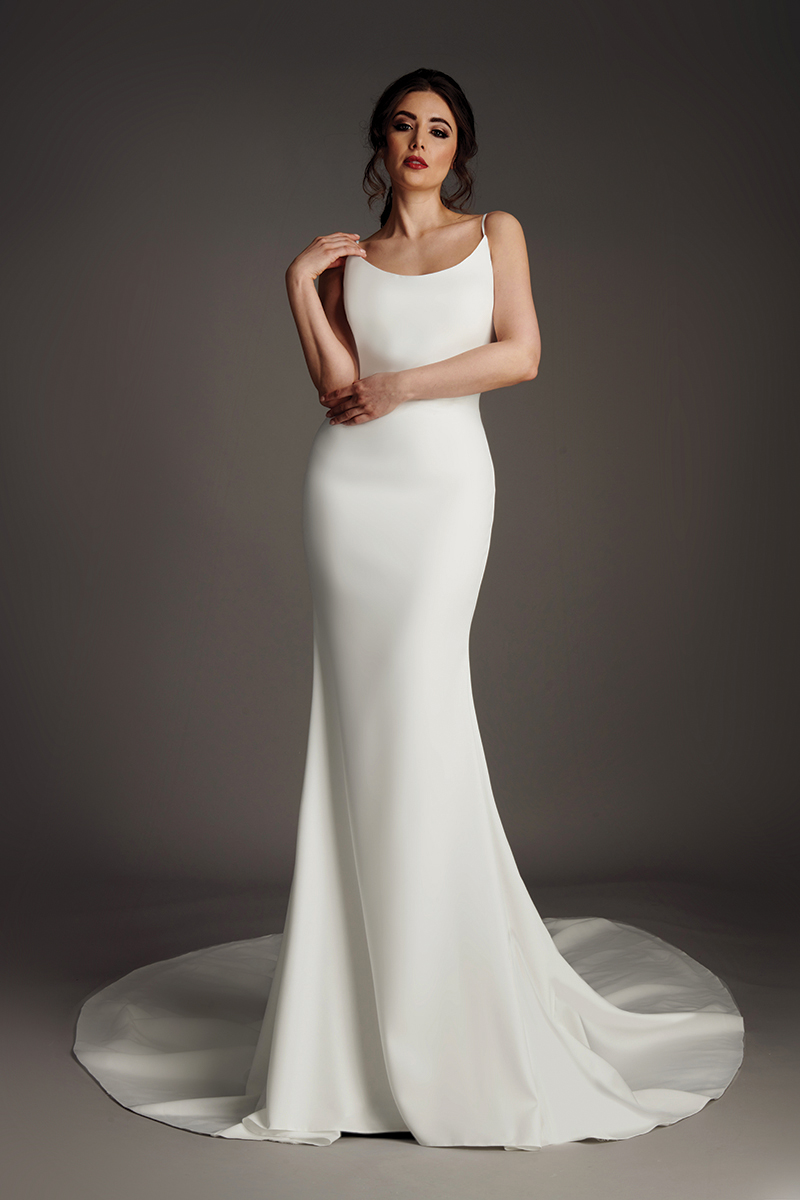 Naomi crepe wedding dress with scoop neckline, fine straps and fitted fishtail skirt.
