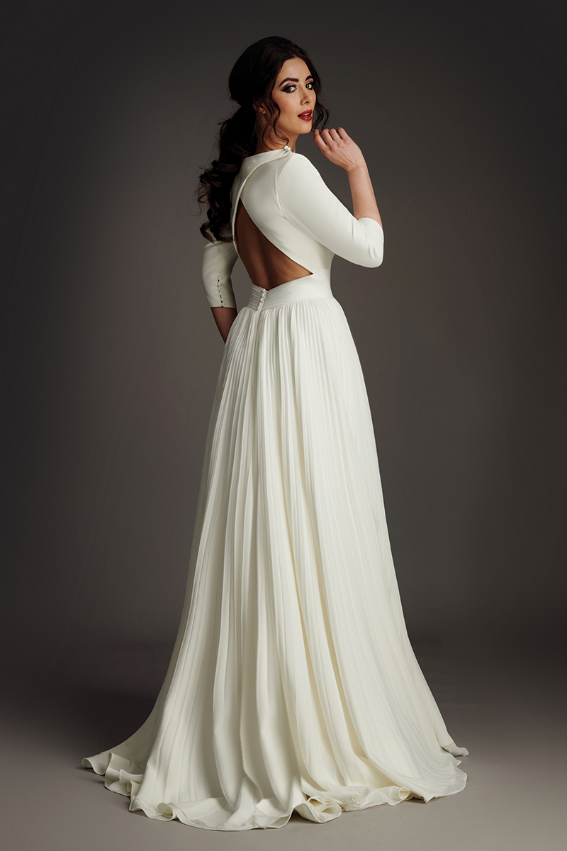 Raffelle wedding dress front view with deep V neckline, modesty panel and buttoned cuffs.