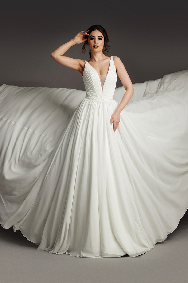 Nicole wedding dress back view with open teardrop back, buttoned cuffs and pleated skirt