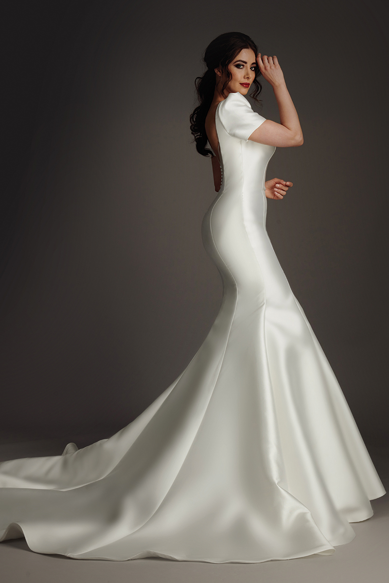 Side view of the Amanda wedding dress showing its fitted fishtail silhouette and sweeping train