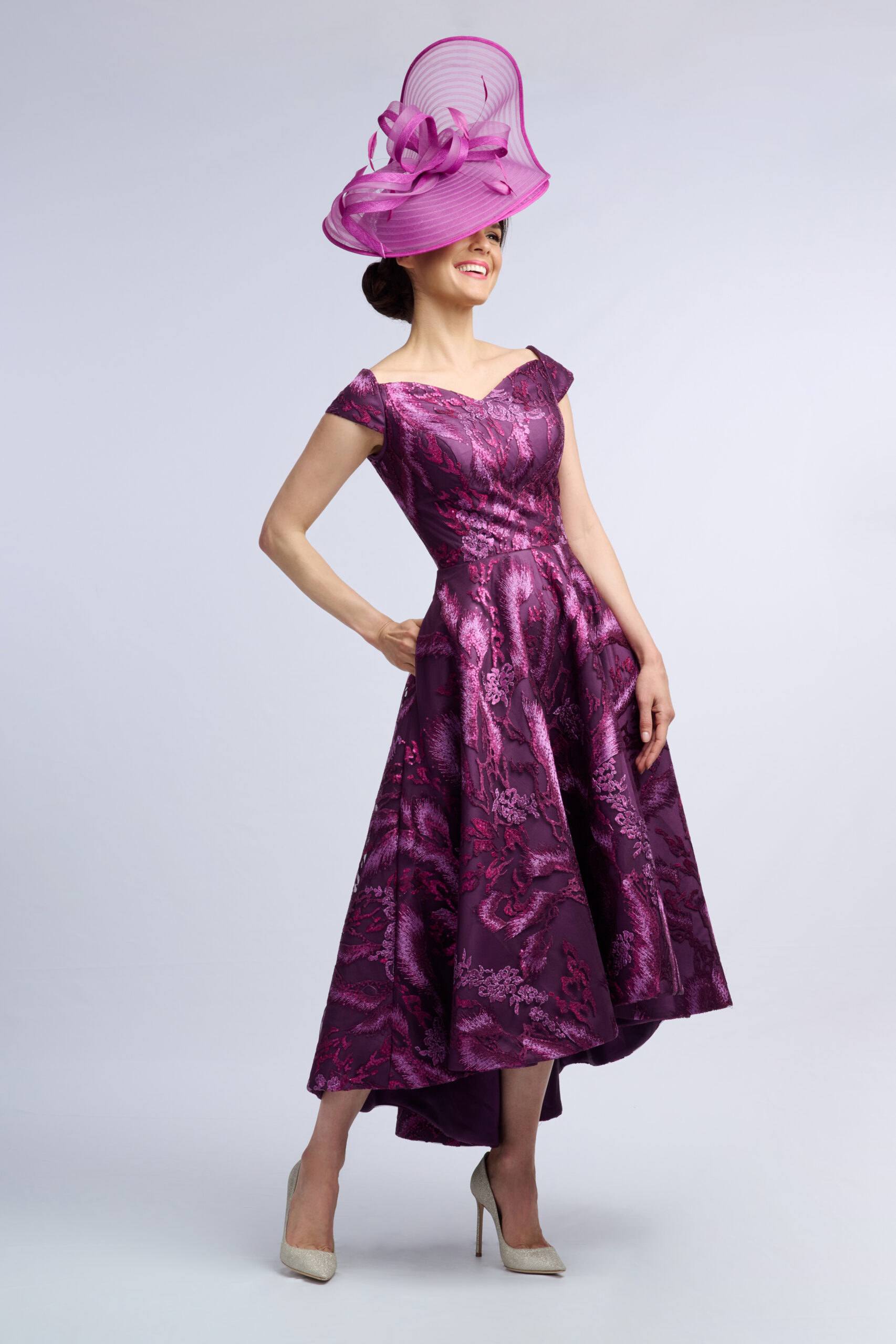 Back of the Aintree occasion dress with V back, navy bodice and pleated high-low printed skirt