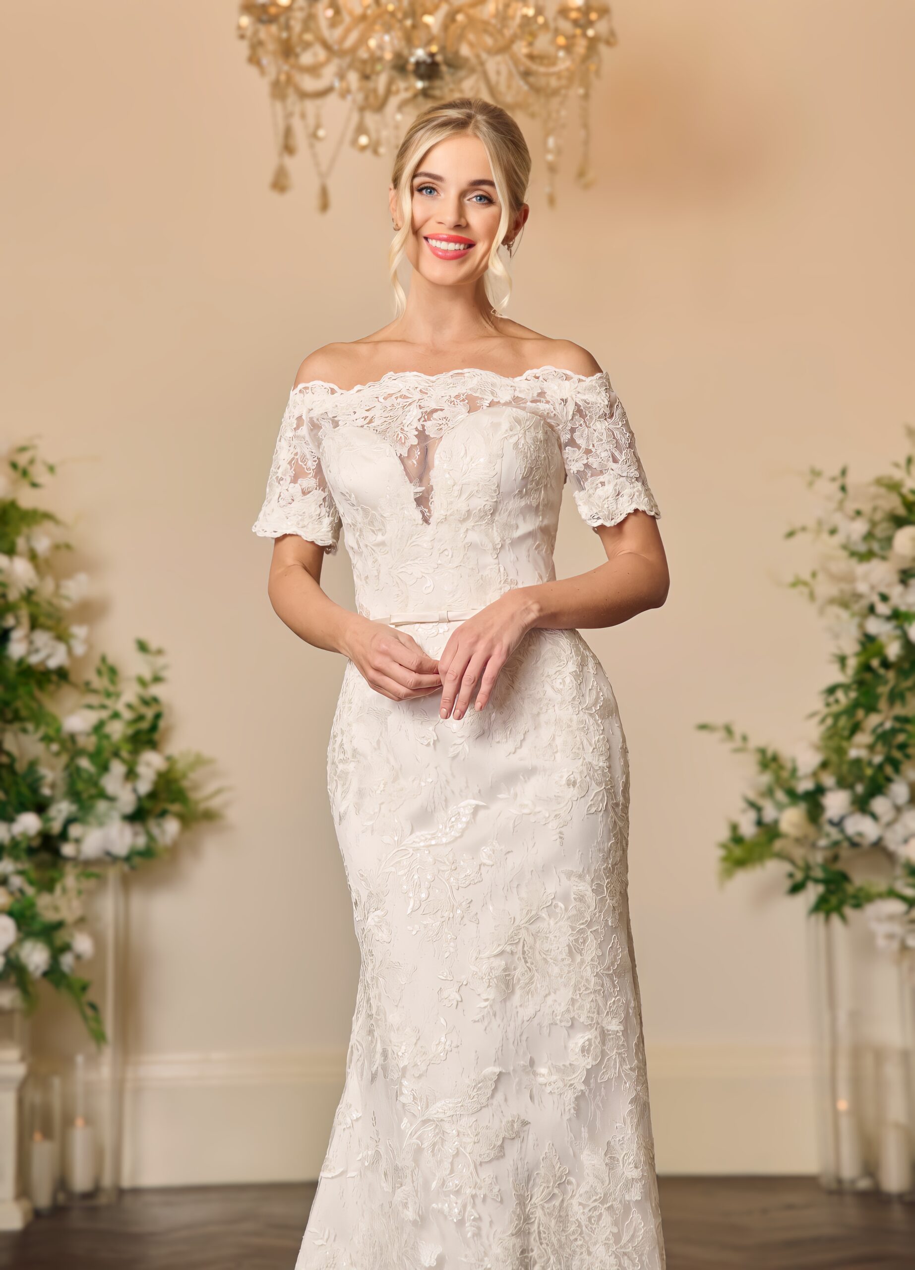 Close view of the Francesca lace wedding dress showing the off-the-shoulder scalloped neckline and short lace sleeves