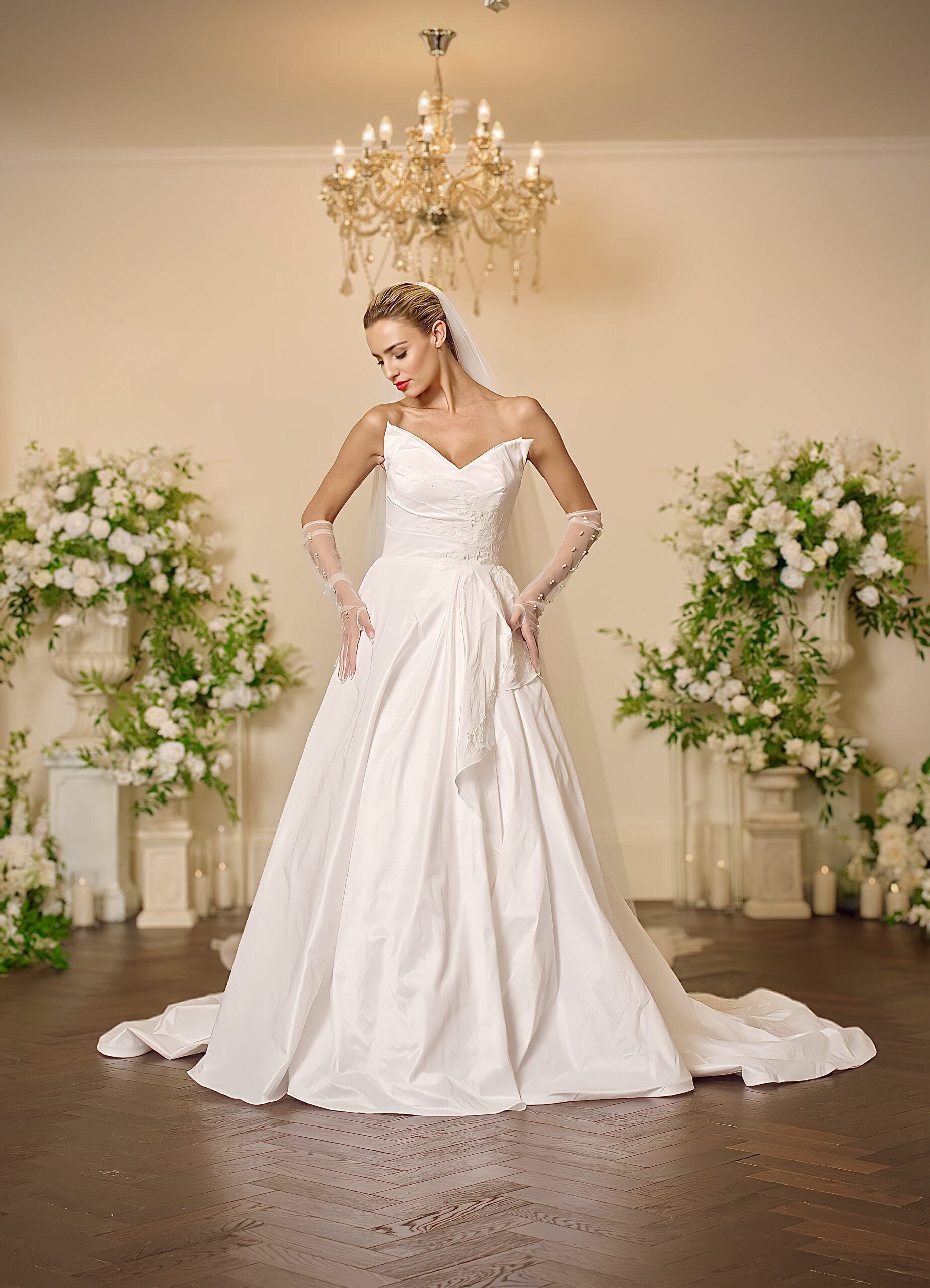 Front view of the Colette ivory taffeta ball gown wedding dress with a strapless sweetheart neckline, crossover ruched bodice and softly draped pleated skirt.