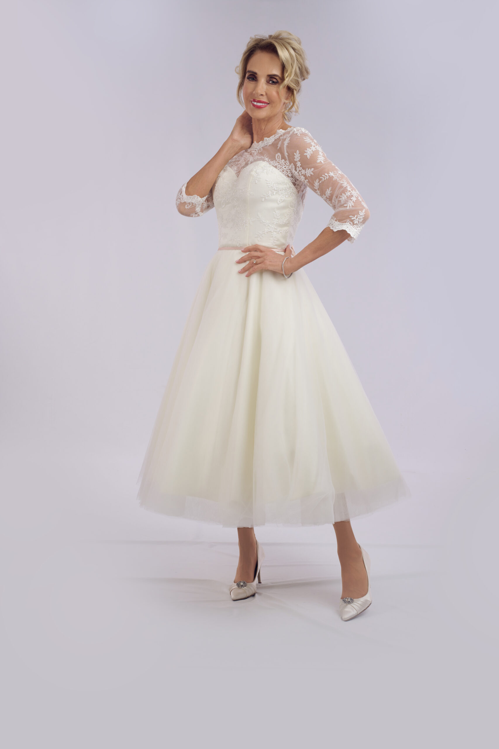 Della vintage tea length wedding dress for older brides, with a lace illusion neckline and three-quarter sleeves