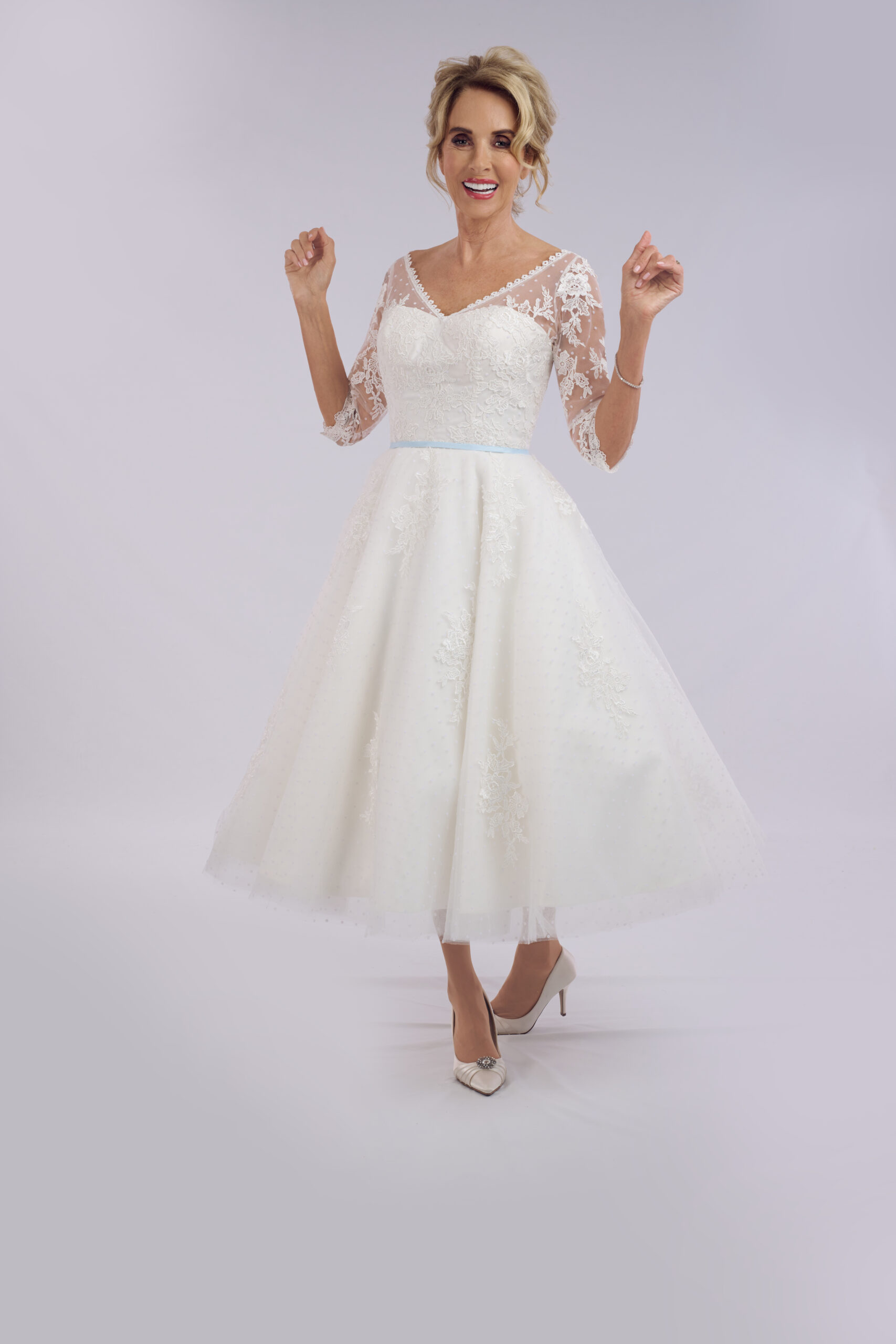 Serenity corset ballerina length wedding dress for older brides, with a sheer lace bodice and puff sleeves