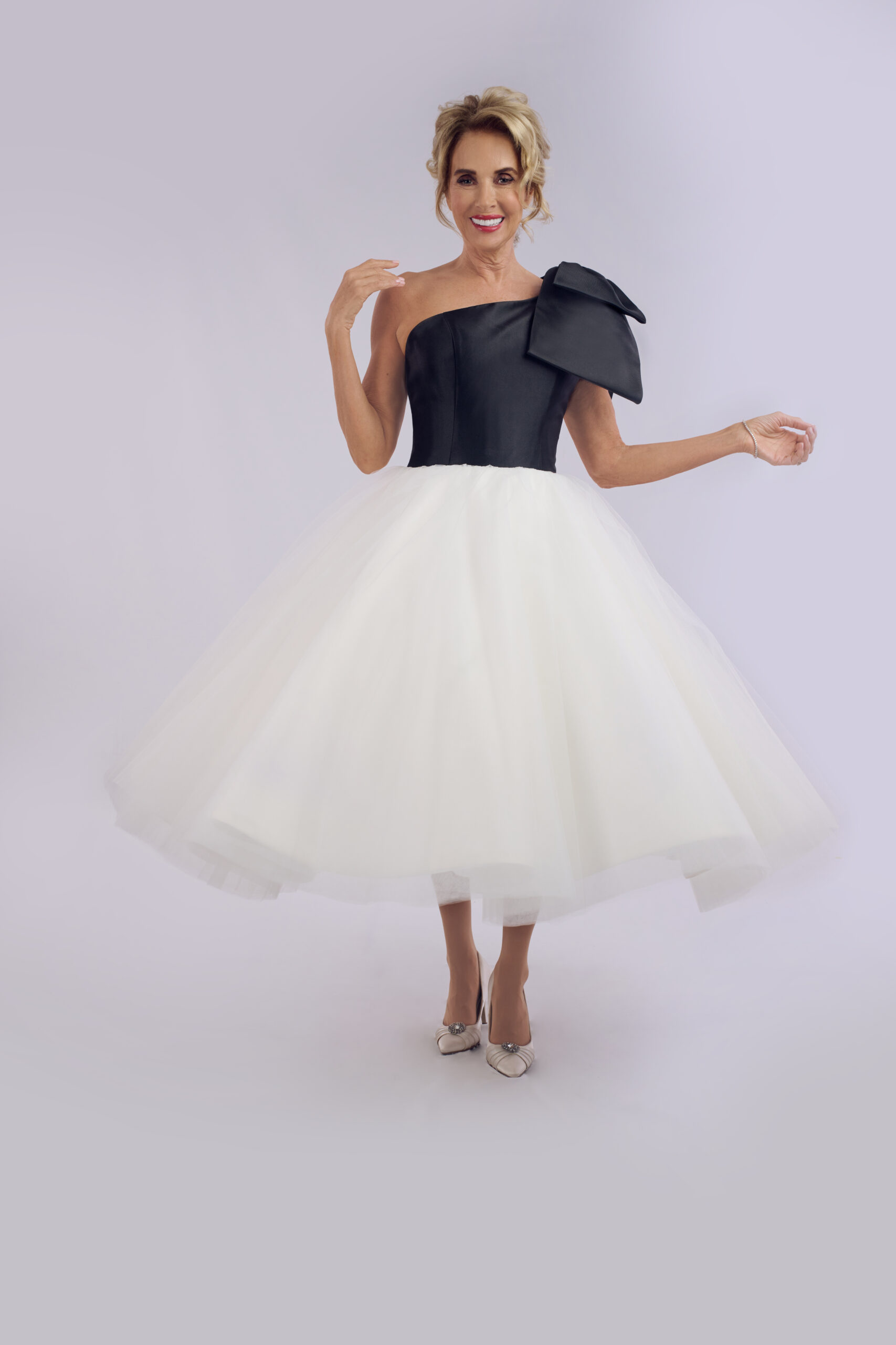 Blake black and ivory tea length wedding dress for older brides, with a one-shoulder bow bodice and full tulle skirt