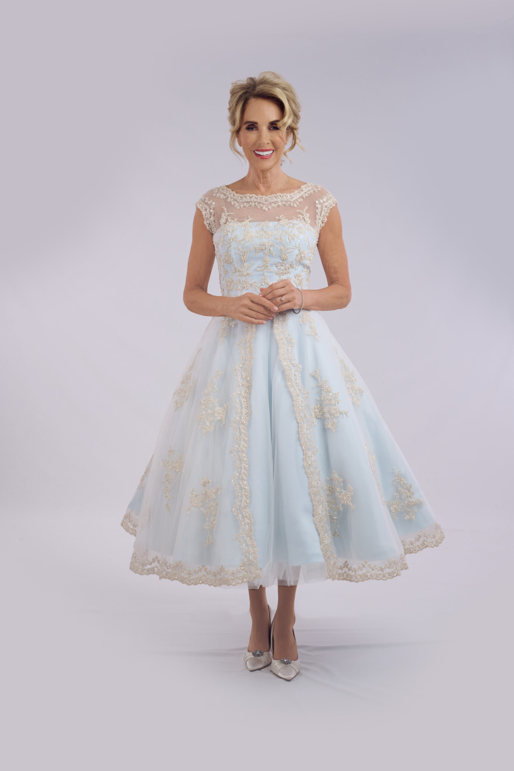 Cordelia pale blue tea length wedding dress for older brides, with an illusion lace neckline and cap sleeves