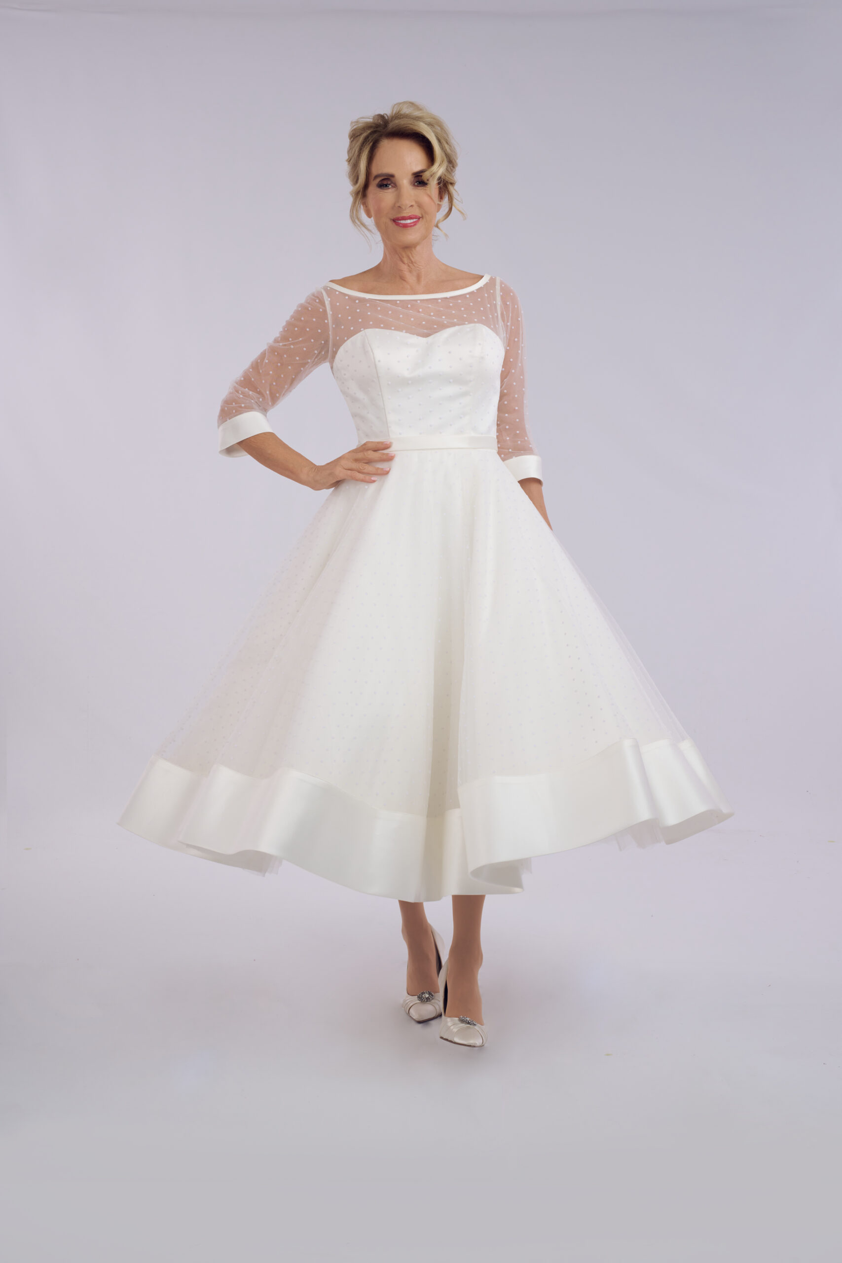 Josie polka dot spot tulle tea length wedding dress for older brides, with an illusion neckline and three-quarter sleeves