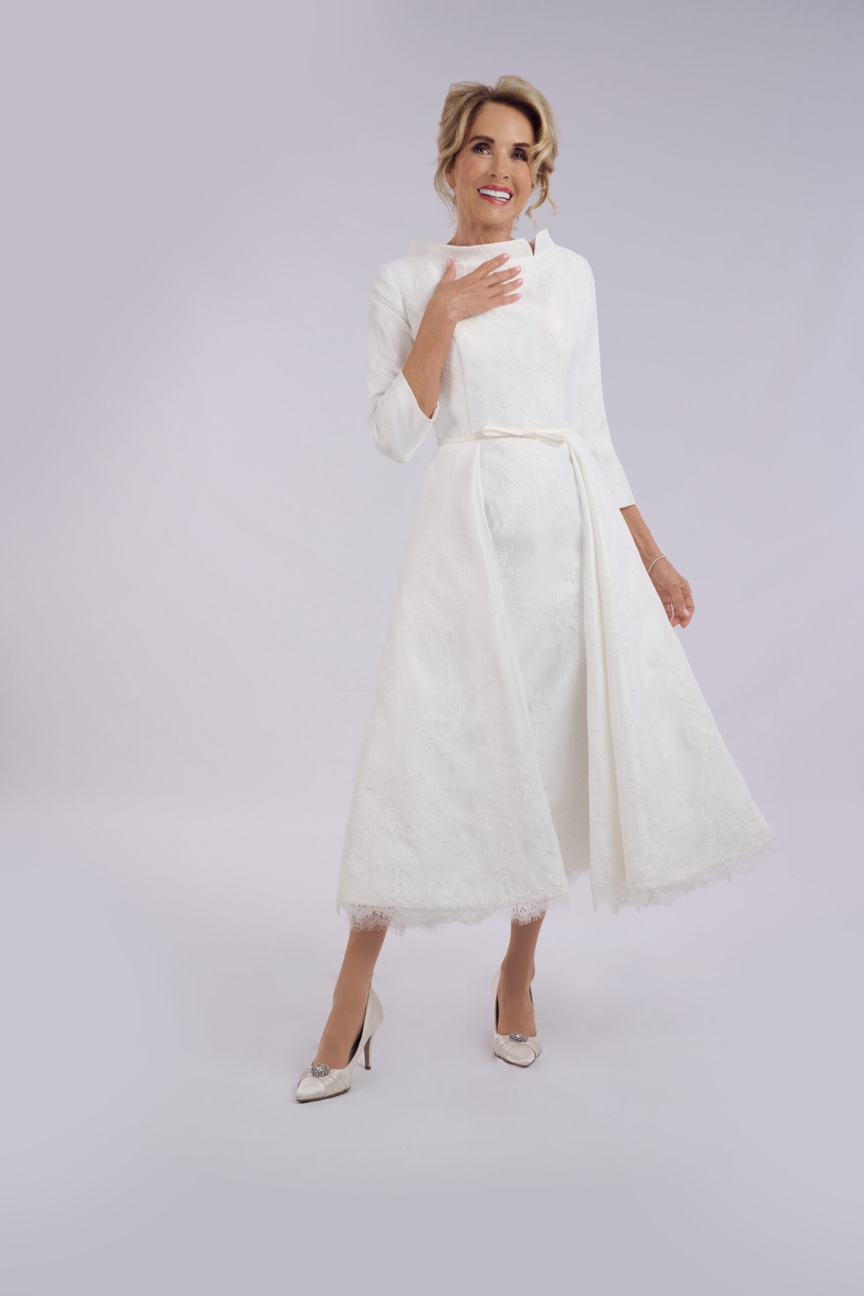 Lucia long sleeve tea length wedding dress for older brides, with a high funnel neckline and lace overlay