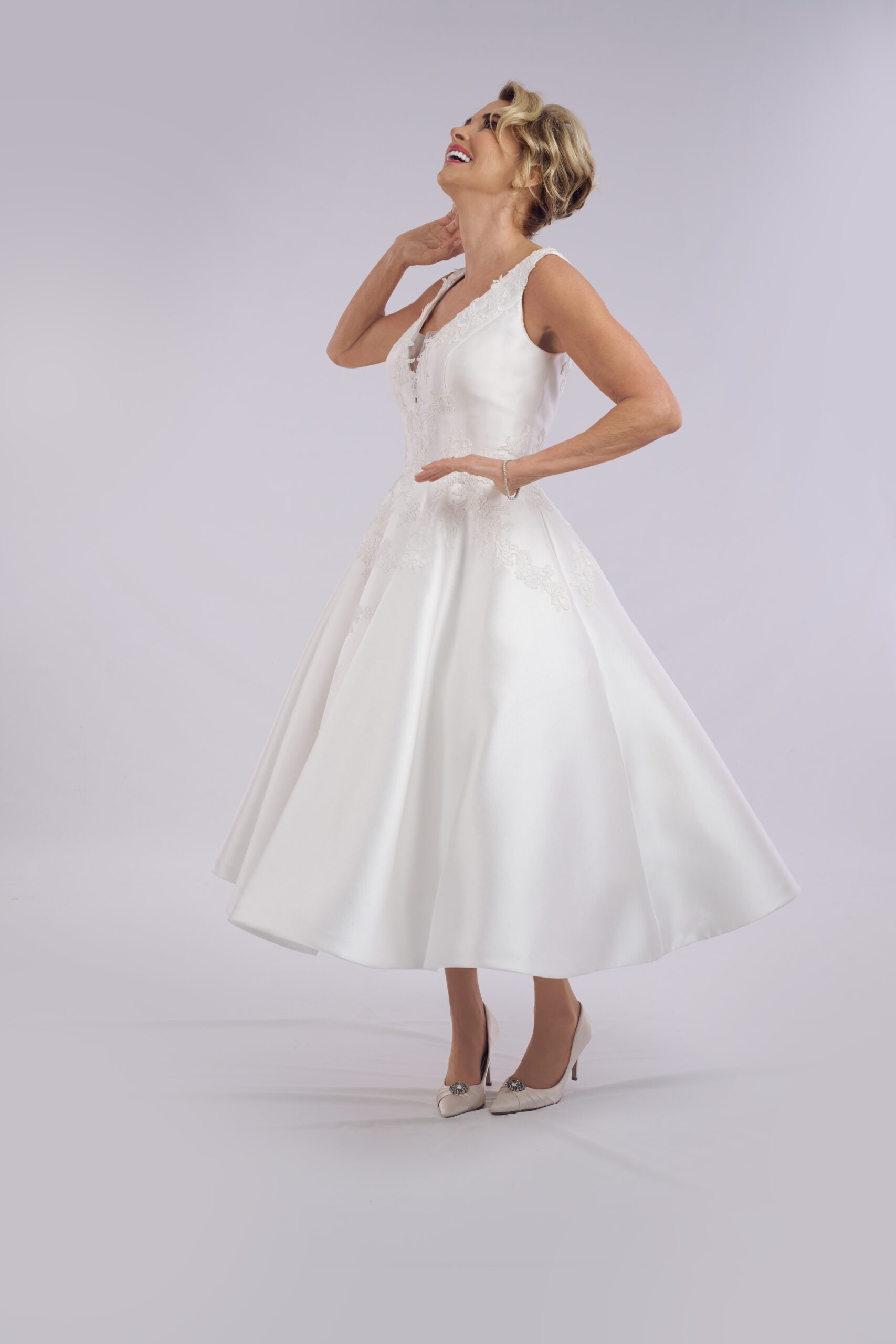 Serenity corset ballerina length wedding dress for older brides, with a sheer lace bodice and puff sleeves