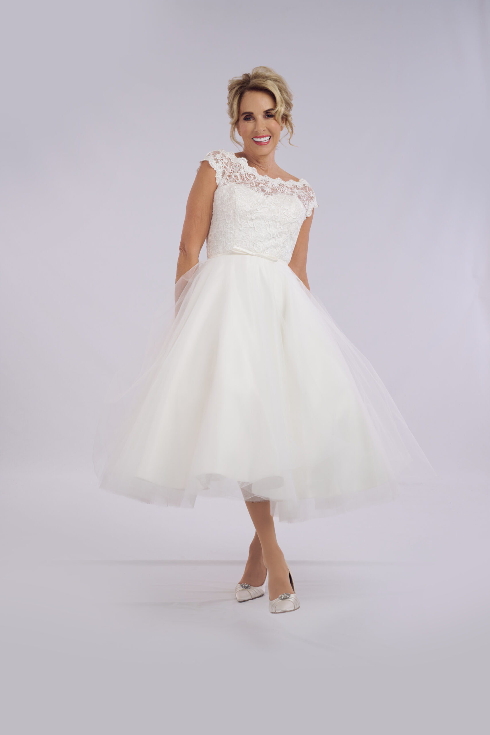 Minnie lace bardot tea length wedding dress for older brides, with a scalloped neckline and full tulle skirt