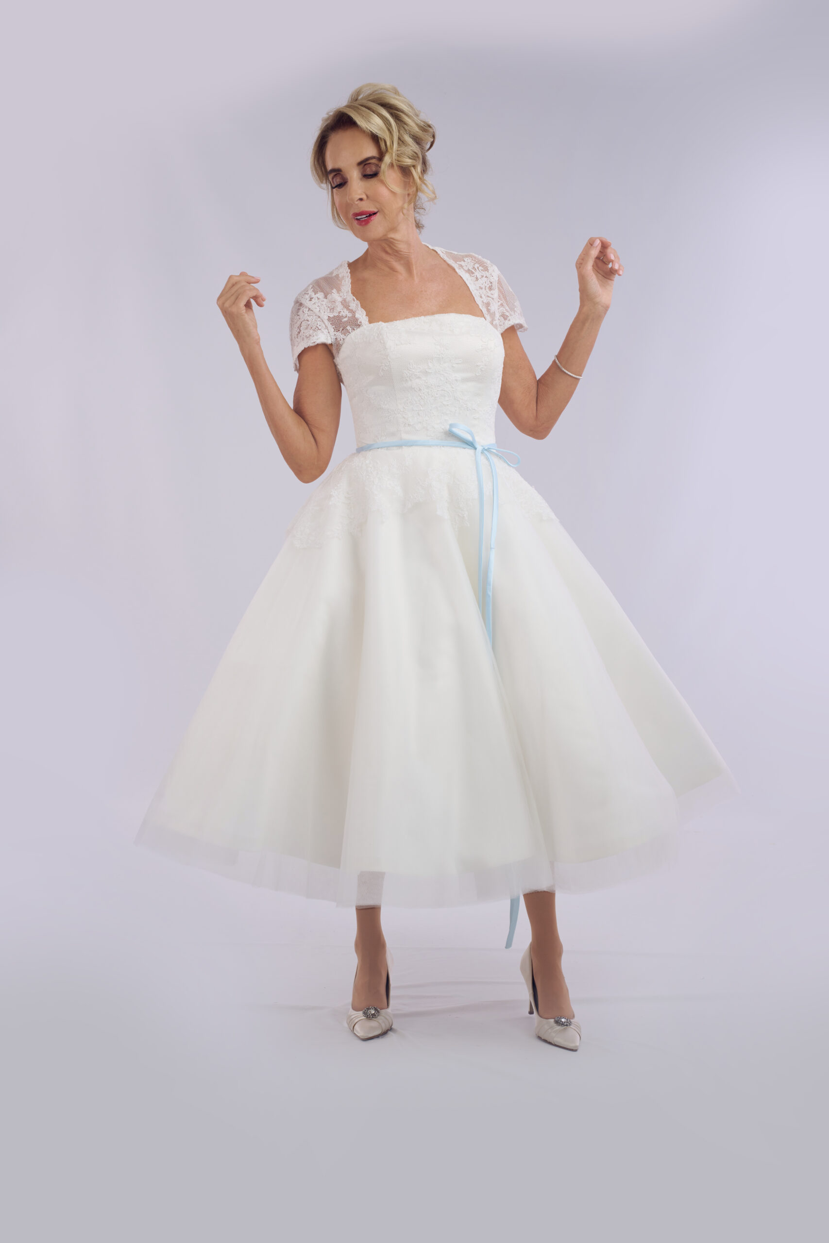 Raya vintage tea length wedding dress for older brides, with a lace bolero and full tulle skirt