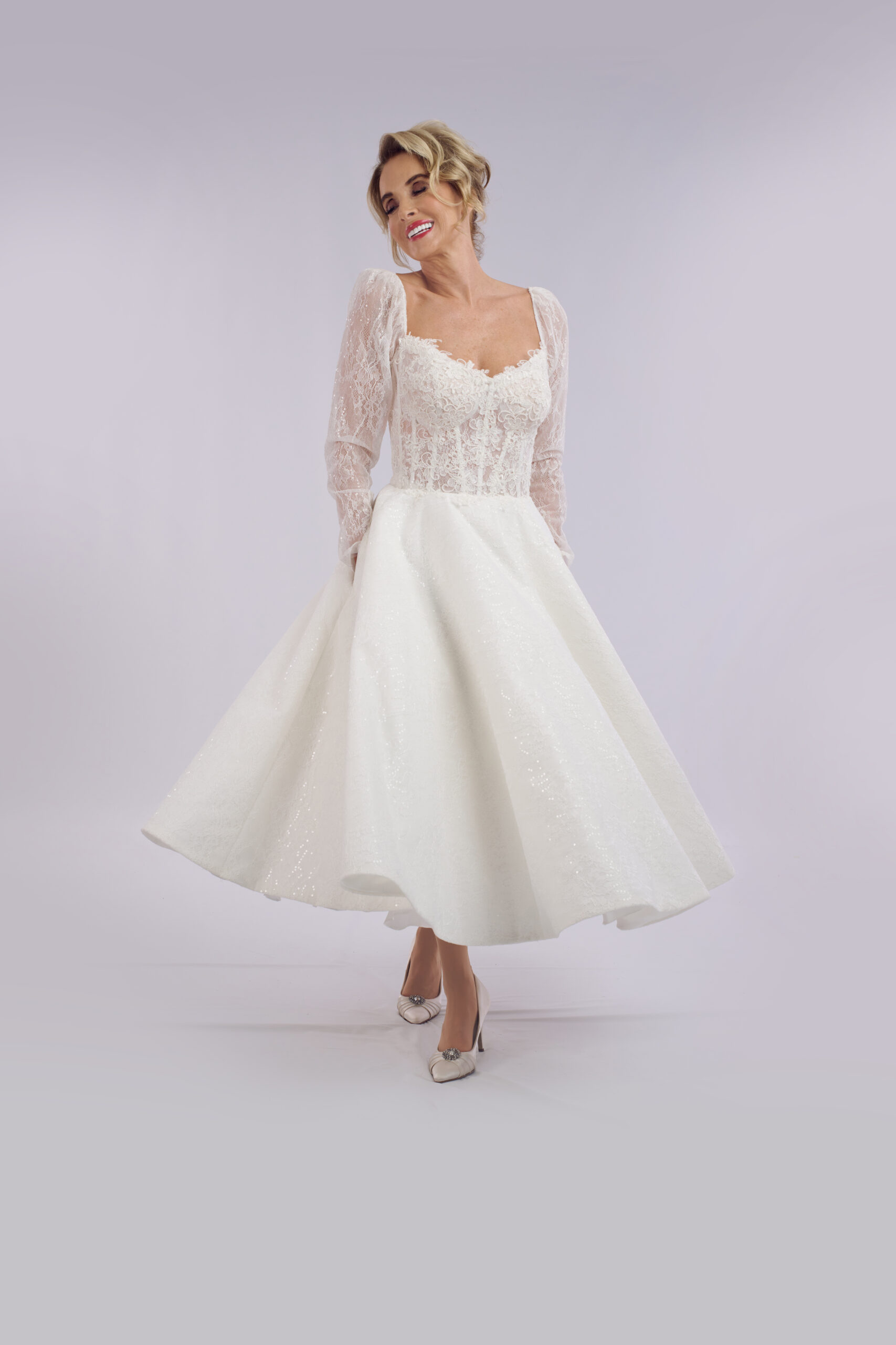 Serenity corset ballerina length wedding dress for older brides, with a sheer lace bodice and puff sleeves