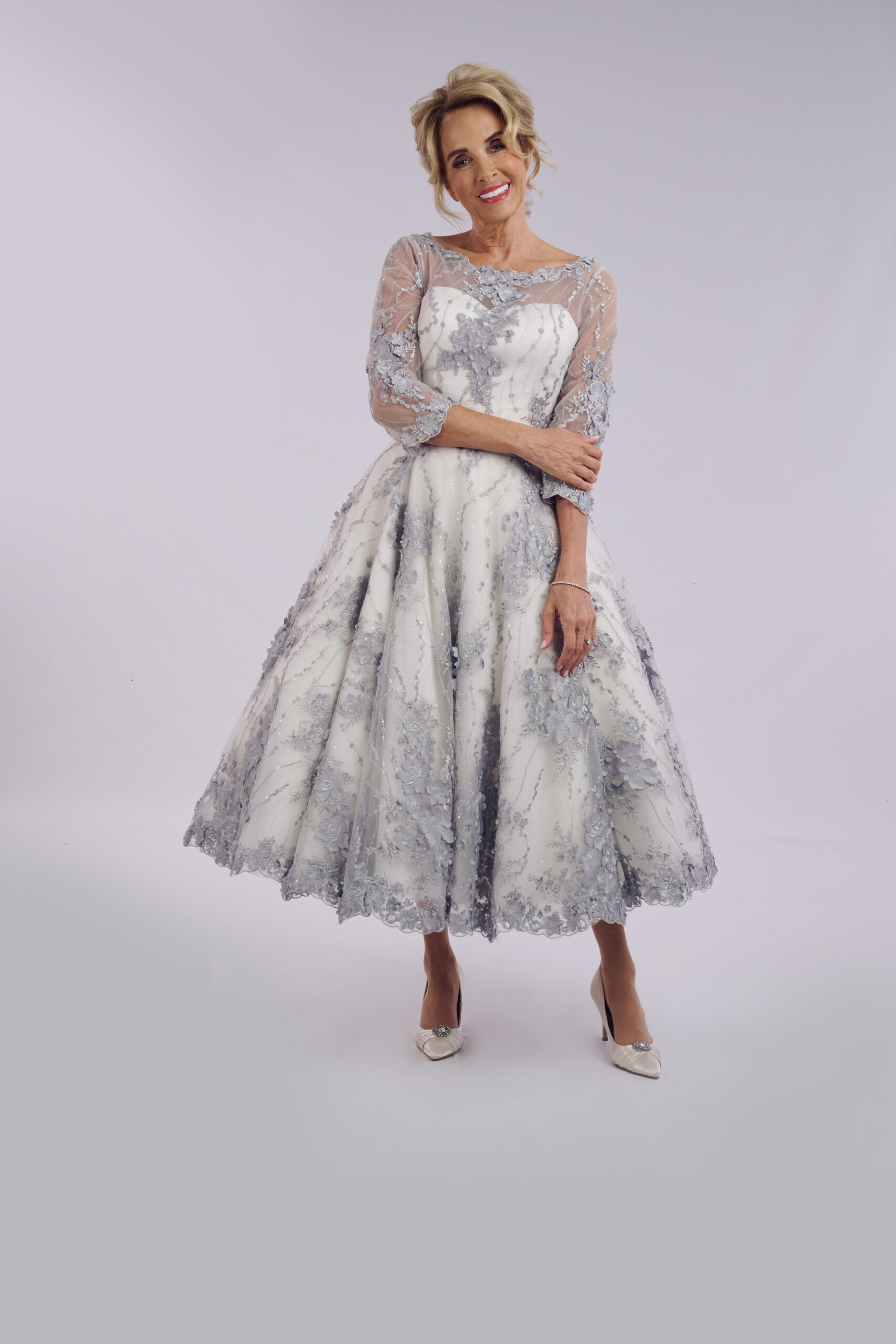 Sybil grey floral ballerina length wedding dress for older brides, with an illusion neckline and sheer sleeves