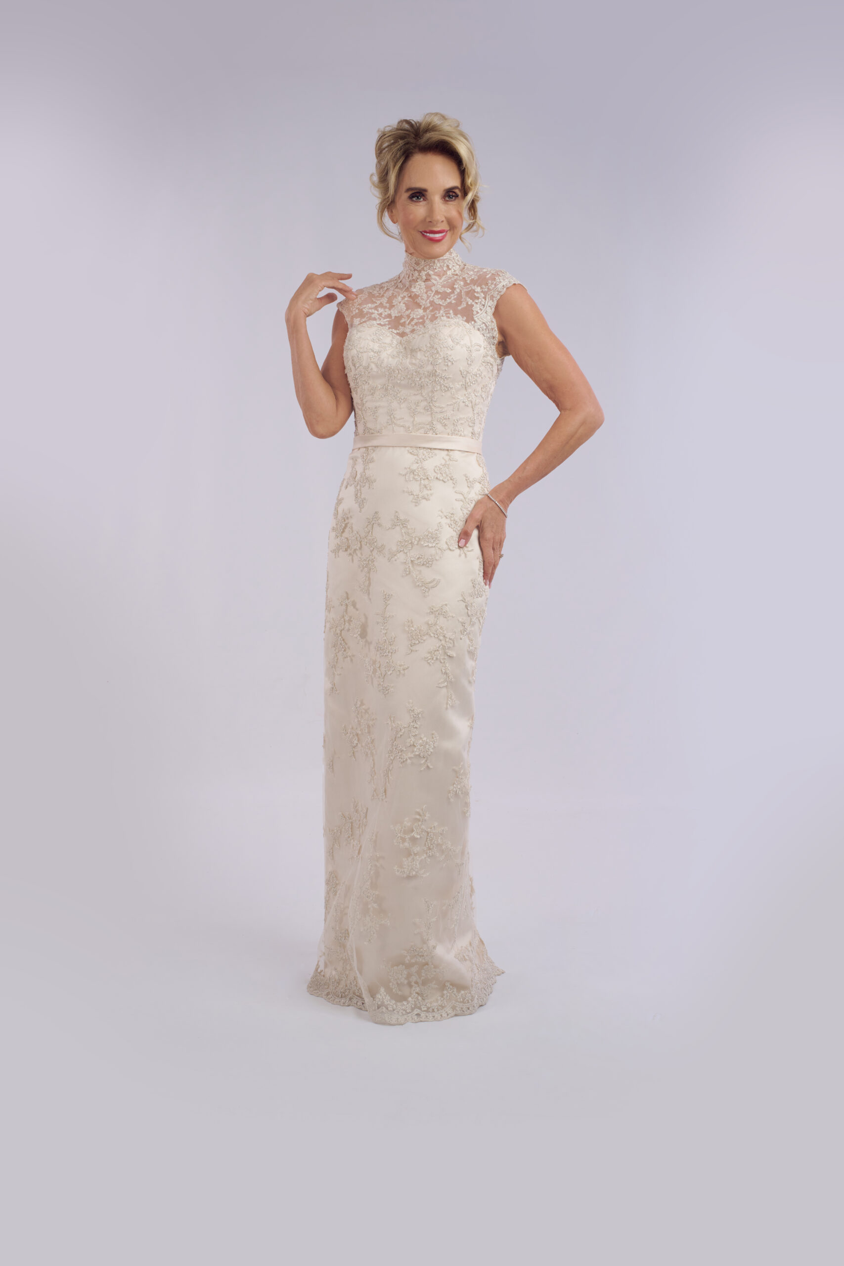 Sylvia fitted lace wedding dress for older brides, with a high illusion neckline and cap sleeves